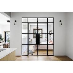 an open glass door leading to a bedroom