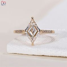 a fancy diamond ring on top of a napkin