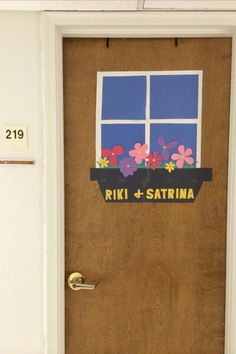 a door decorated with flowers and the words riki & sattrina on it