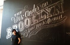 a woman standing in front of a blackboard with writing on it that says, the under one book is brooklyn