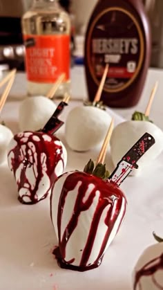 chocolate covered strawberries are sitting on a white table with toothpicks sticking out of them