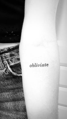 a black and white photo of a person's arm with the word obhigate tattooed on it