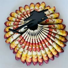 an arrangement of multicolored crayon pencils arranged in the shape of a fan