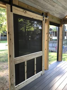 a screened porch with sliding glass doors on the outside and wood flooring in front