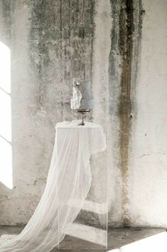 a white table with a veil draped over it