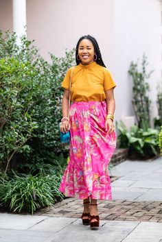 The Benada maxi wrap skirt is perfect for day or night! Our exclusive hot pink print features fun details including lions and palm trees. This maxi skirt includes a true wrap feature, button closure with an adjustable bow tie, pockets and an elastic waistband. Skirt length: 36”. 100% cotton, machine wash: cold, tumble dry: low. Illustrated and designed in Charleston, SC by Mimi's mom, Keiko! Mimi is 5'3" and wearing a size small. Our apparel is designed and made to fit comfortably, please refer Pink Maxi Bottoms For Vacation, Tropical Print Skirt For Day Out, Casual Pink Wrap Skirt For Beach, Casual Pink Wrap Skirt For The Beach, Spring Tropical Print Skirt For Day Out, Spring Day Out Tropical Print Skirt, Spring Tropical Print Flowy Skirt, Tropical Print Skirt For Summer Day Out, Summer Tropical Print Skirt For Day Out