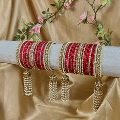 Stunning and unique set of red bangles with pearl kaleereh detailing, comes as a pair for both arms.  With antique gold bangles and champagne zircon crystals. Hot pink metal bangles and beautiful long Kaleereh jhumka bangles! Perfect for your special day  Very limited stock!  Ready to ship 📦 Cheap Red Festive Bangle, Luxury Handmade Bangle For Festive Occasions, Red Hand Set Bangle For Party, Red Stone Work Bangle Jewelry, Red Bracelets With Stone Work For Gift, Red Stone Work Bracelets As A Gift, Festive Celebration Bracelets With Latkans, Festive Celebration Bangle, Red Bollywood Bracelets For Celebration