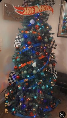 a christmas tree decorated with racing cars and lights