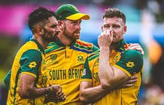 three men in yellow and green uniforms standing together