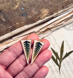 Beautiful and simple fern earrings on gold triangles. Dark green fern leaves on natural color, off white backgrounds, set with resin inside gold triangles.  These fern earrings are just over 2" long from the tops of gold tone earring hooks. Dried Greenery, Green And Gold Earrings, Fern Earrings, Earrings Triangle, White Backgrounds, Fern Leaves, Fern Leaf, Botanical Jewelry, Triangle Earrings