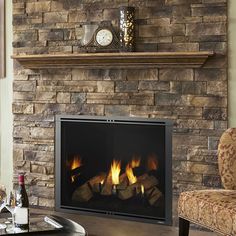 a living room with a fire place in the center and a clock on top of it