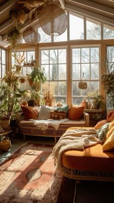 a sun room filled with lots of plants and furniture