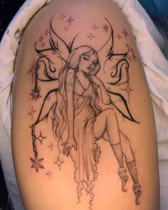 a woman with long hair and tattoos on her arm is sitting in front of the moon