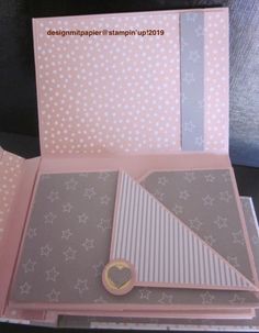 the inside of a pink card with white stars on it