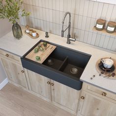 a kitchen with two black sinks and wooden cabinets