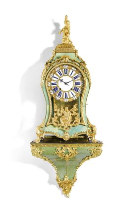 an ornate gold and green clock with roman numerals on the face is shown against a white background