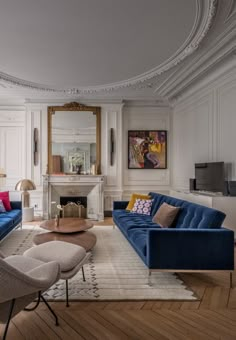 a living room filled with furniture and a fire place next to a wall mounted tv