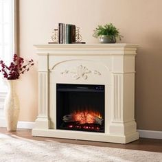 a living room with a fire place and a vase on the floor next to it