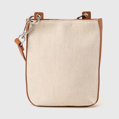 The Harper Phone Bag by Urban Originals is a stylish accessory crafted from a combination of canvas and vegan leather in a two-tone design. Featuring a front pocket, this small-sized wallet is perfect for carrying your essentials in a compact and fashionable way. Trendy Coated Canvas Shoulder Bag For Errands, Canvas Crossbody Bucket Bag For On-the-go, Beige Shoulder Bag With Leather Trim For On-the-go, Casual Beige Bucket Bag With Leather Trim, Brown Canvas Bucket Bag With Leather Trim, Brown Canvas Bucket Bag For On-the-go, Trendy Canvas Bucket Bag In Pouch Shape, Trendy Canvas Pouch Bucket Bag, Trendy Canvas Bucket Bag