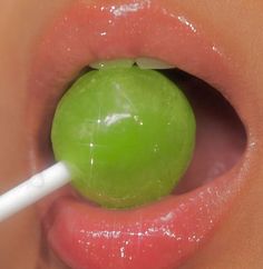 a green apple is sticking out of the lip