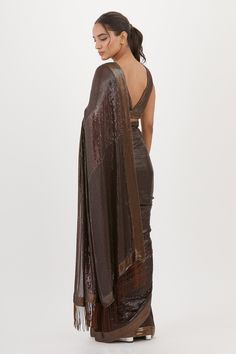 Brown saree with sequin work and fringe pallu. Paired with embroidered sleeveless blouse.
Components: 2
Pattern: Embroidered
Type Of Work: Sequin
Neckline: Plunge V Neck
Sleeve Type: Sleeveless
Fabric: Chiffon
Color: Brown
Other Details: 
Sequin work
Embroidered blouse
Occasion: Sangeet,Reception - Aza Fashions Saree With Sleeveless Blouse, Blouse For Women, Work Sarees, Blouse Online, Embroidered Blouse, Aza Fashion, Sleeveless Blouse, Types Of Sleeves, Sequin