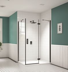 a white and black tiled bathroom with a walk in shower next to a blue wall