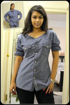 a woman standing in front of a mirror with her hands on her hips and looking at the camera