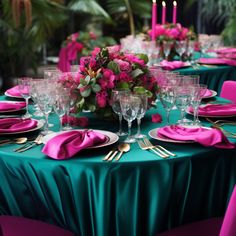 the table is set with pink flowers and green cloths for an elegant dinner party