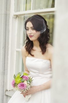 a woman in a wedding dress holding a bouquet