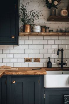 a kitchen with black cabinets and white subway tile backsplash, wooden counter tops