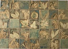 the tile is decorated with flowers and leaves