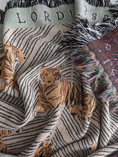 a blanket with tiger designs on it and the word lord is written in large letters