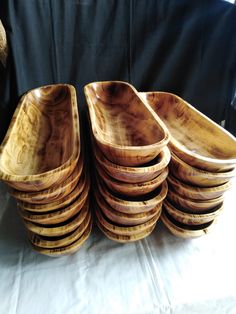 a stack of wooden bowls sitting on top of a table