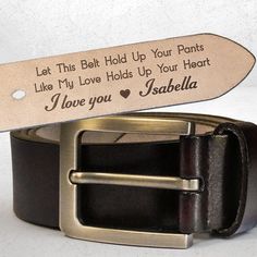 a leather belt with an engraved message on the side and a metal buckle that says, let this belt hold up your pants like my love holds up your heart i love you