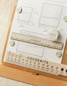 a close up of a ruler and some buttons on a piece of paper that says coconutnuts