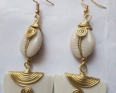 Wholesale African Women Earrings, Gift Jewelries, Cowries Shell Earrings - Etsy UK Metal Shell Earrings For Gift, White Brass Earrings For The Beach, White Brass Earrings For Beach, Handmade Cowrie Shell Earrings For Gift, Handmade Cowrie Shell Earrings As Gift, Brass Shell Earrings For Gift, Gold Cowrie Shell As Gift, Handmade White Metal Earrings, Elegant White Cowrie Shell Jewelry