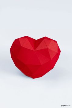 an origami heart shaped box on a white background