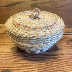 a woven basket sitting on top of a wooden table