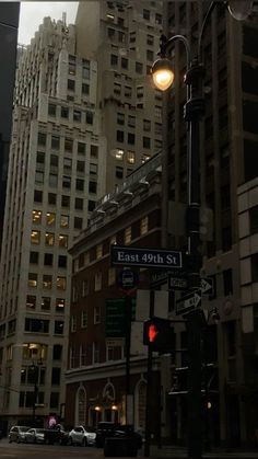 an intersection with street signs and buildings in the background