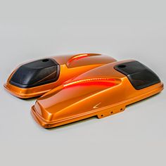 two orange remotes sitting on top of each other