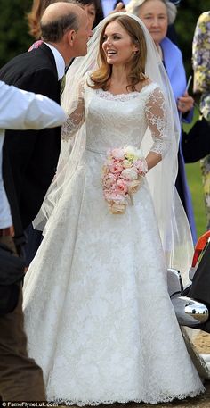 the bride smiles as she walks down the aisle