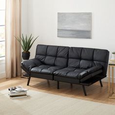 a living room with a black leather couch