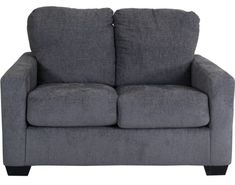 a gray couch sitting on top of a white floor