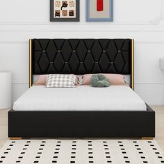 a black and gold bed in a white room with pictures on the wall above it