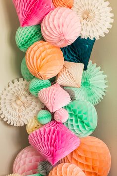 paper honeycombs are arranged on the wall in different colors and shapes for decoration