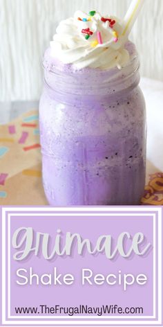 a purple smoothie in a mason jar with sprinkles and a straw