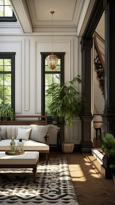 a living room filled with furniture and lots of windows next to a stair case covered in plants