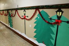 a hallway decorated for christmas with lights and decorations on the wall, along with garlands