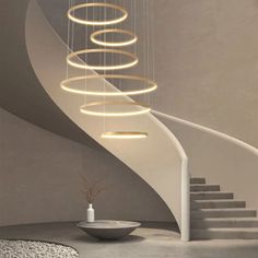 a white staircase with circular lights hanging from it's sides and a bowl on the floor