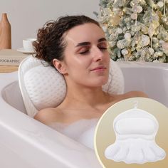 a woman laying in a bathtub with her eyes closed next to a christmas tree